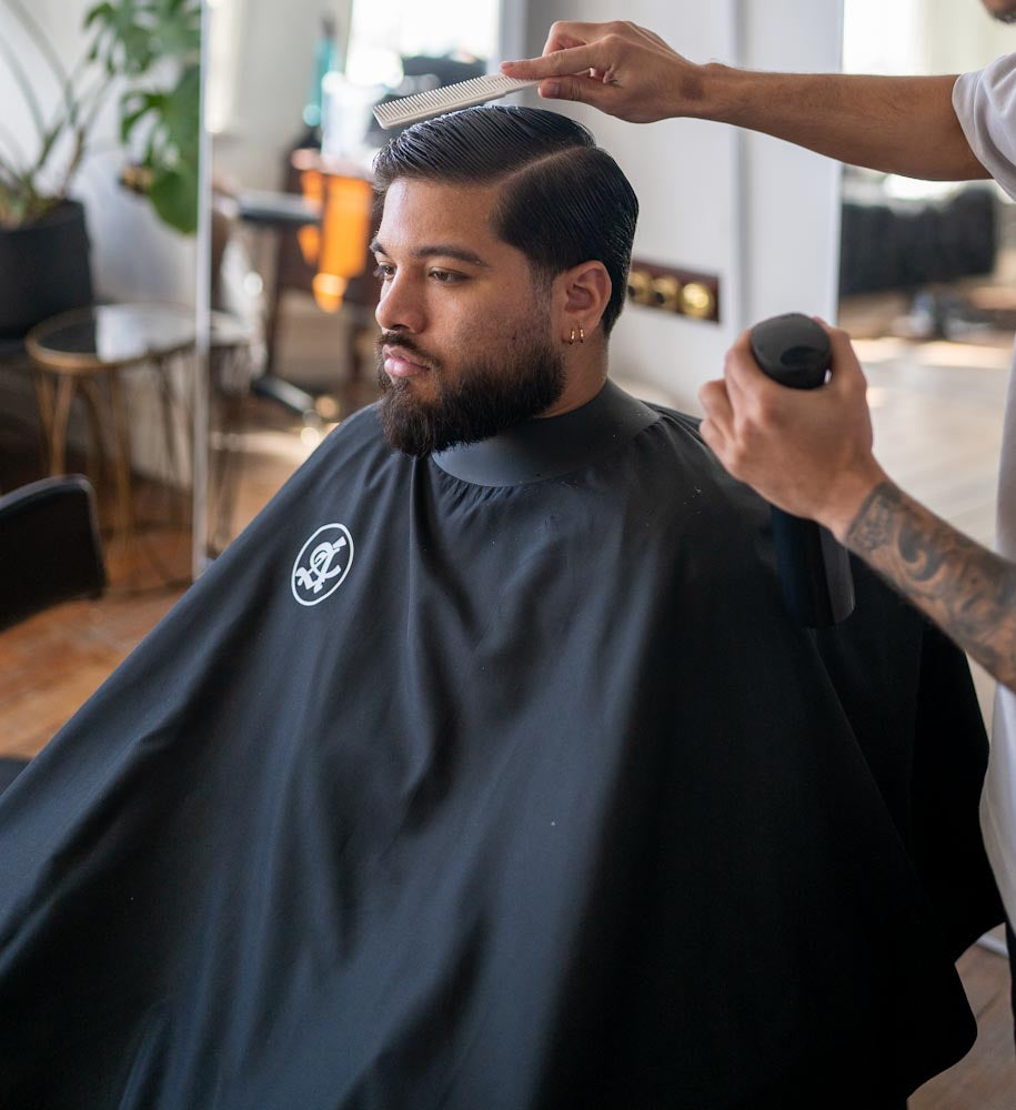 Anomalous Space Black cape in use - barber styling cape Australia