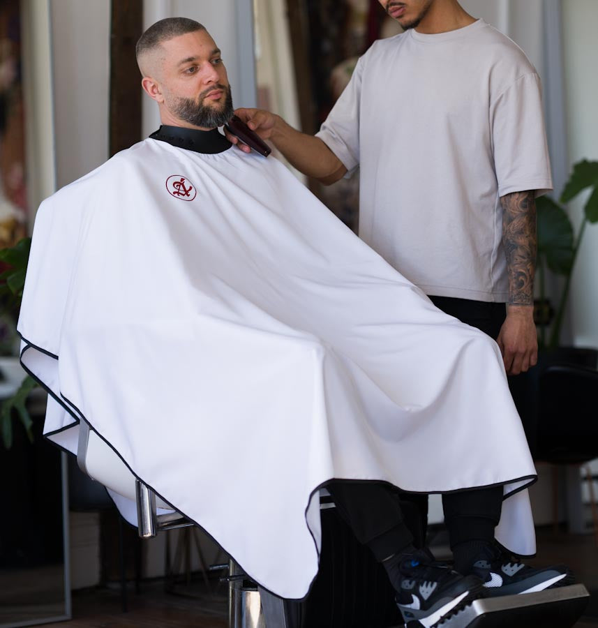 anvas White professional barber cape with double-stitched hem and extra hold buttons